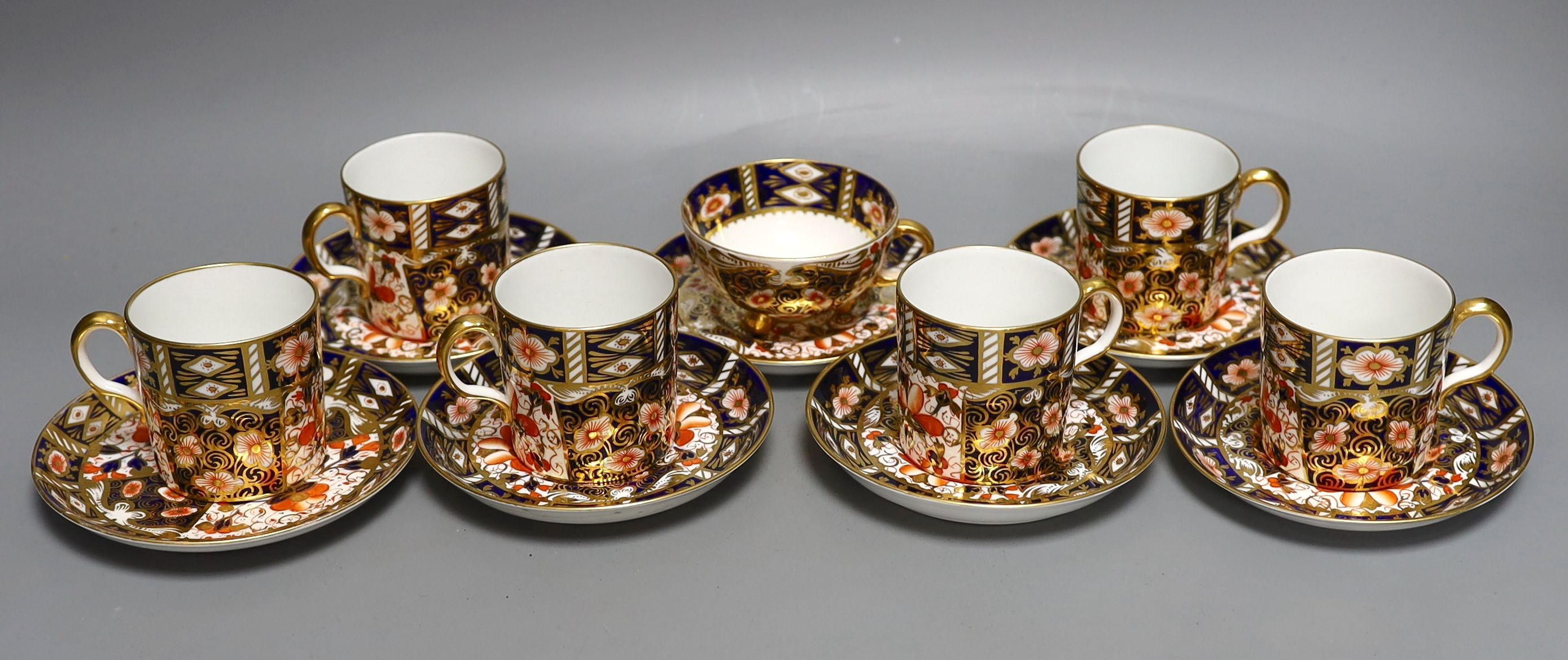 A Royal Crown Derby 6 set of coffee cans, 7 saucers and a similar Davenport cup and saucer (14)